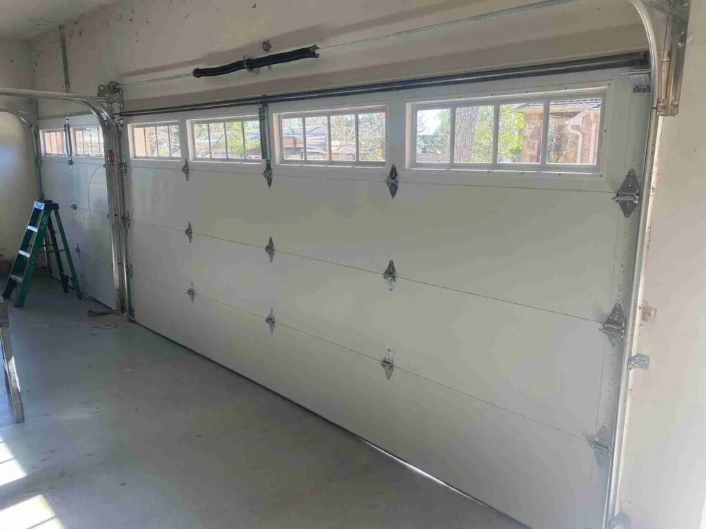 Inside view of a white garage door with window panels